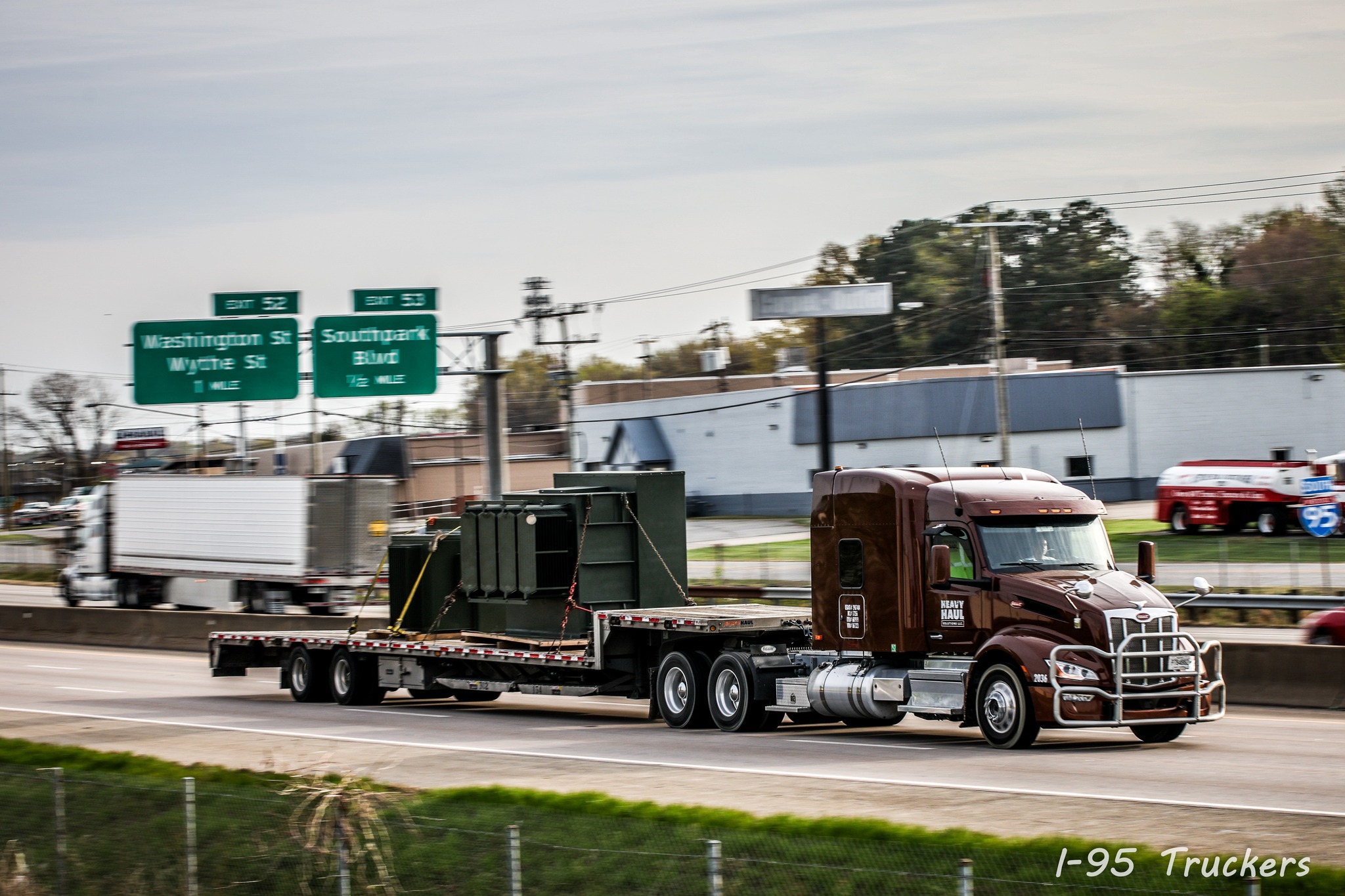 An HHS flatbed running general open-deck freight on the highway