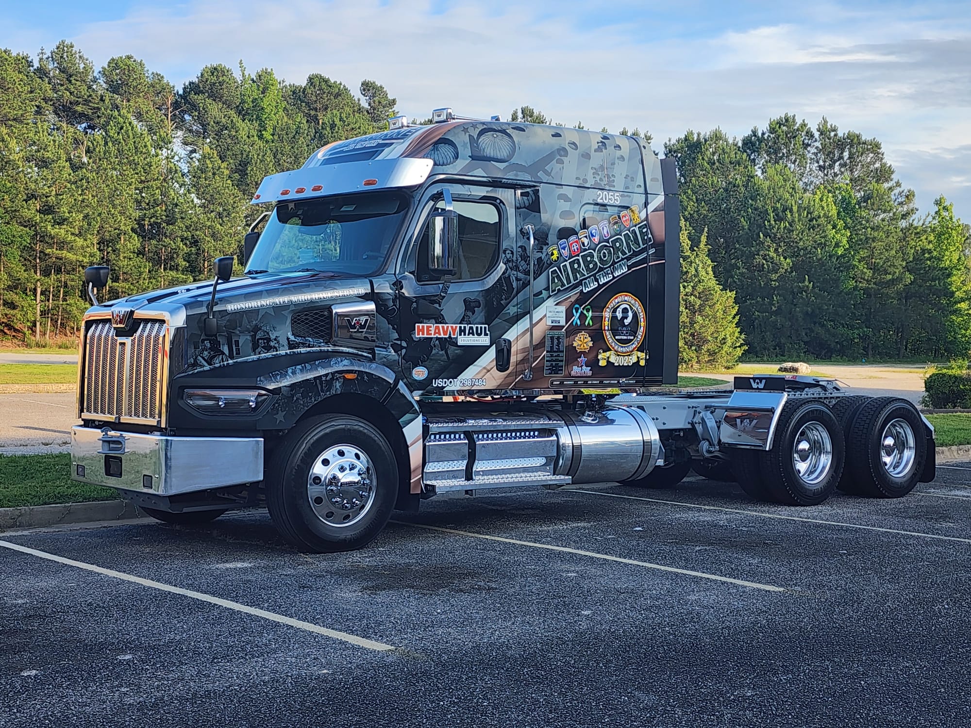 The HHS Airborne tribute truck, wrapped &ldquo;Honoring All Who Have Served&rdquo; with unit patches and a POW/MIA emblem