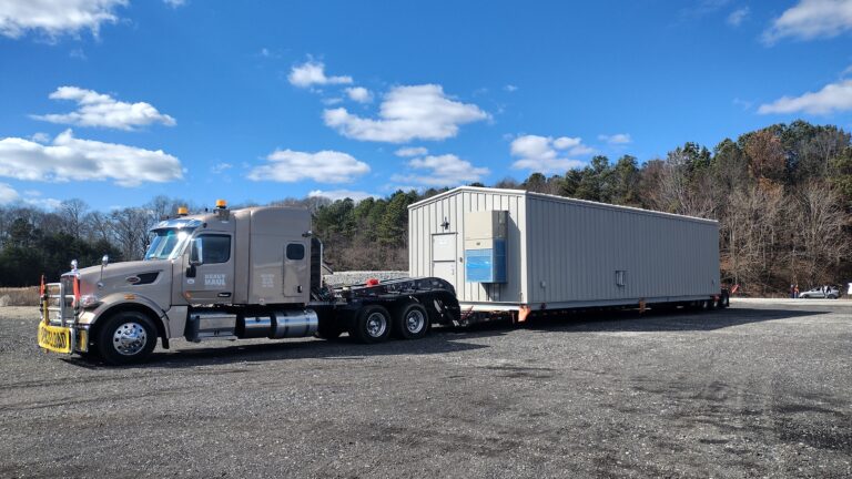 Semi tractor hauling a modular building.