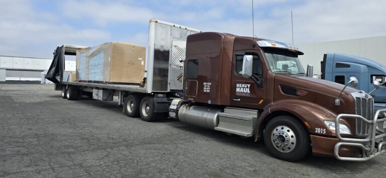 Heavy Haul Solutions truck hauling a Conestoga trailer