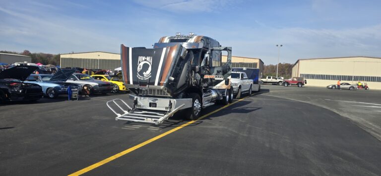 Heavy Haul Solutions Airborne truck at airport facility with with car show vehicles nearby. Ralph Sisk Memorial Car Show.